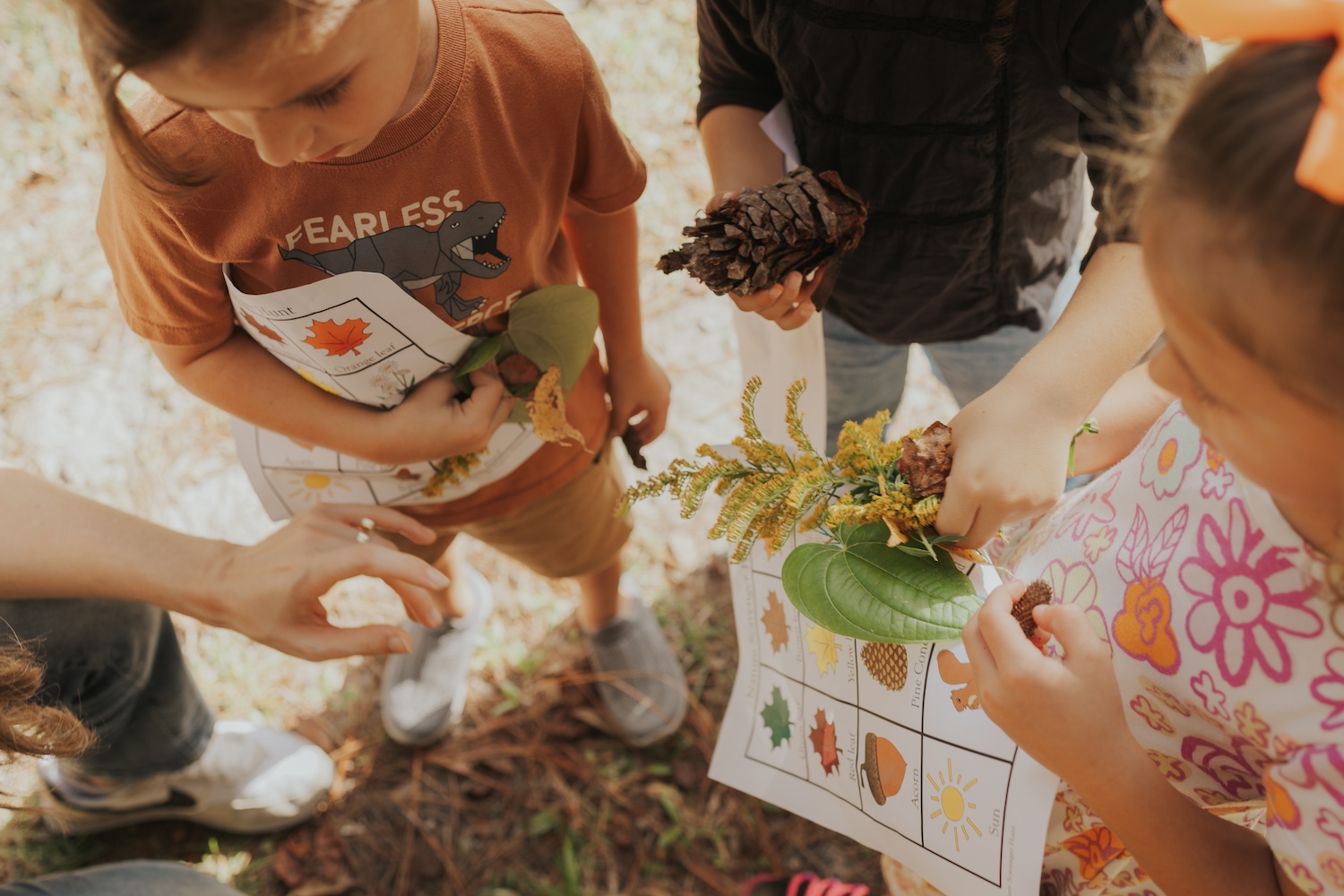 Several children doing an outdoor activity with plants